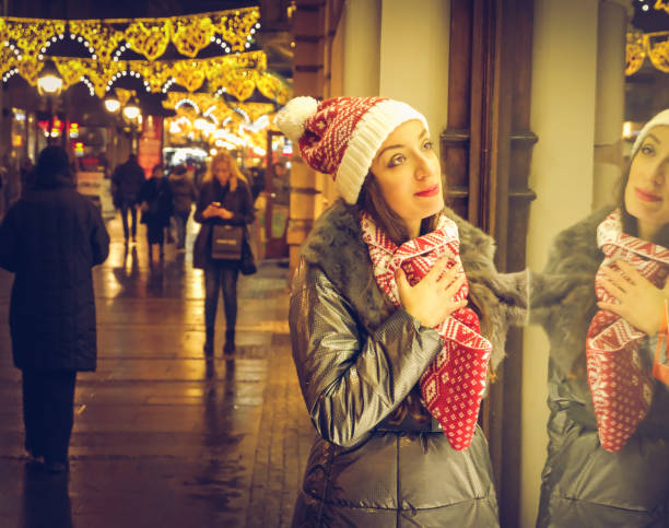 istock woman looking at shop window,christmas time 886107510
