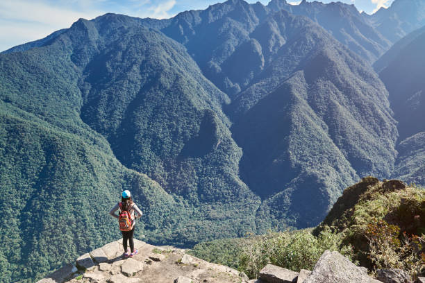 istock Woman stand on mountain peak 886110208