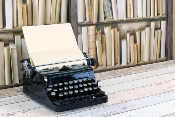 istock Vintage black typewriter on an old desktop with an old bookcase background 886121802
