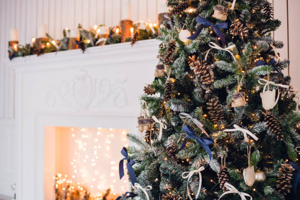 istock Christmas background with illuminated fir tree and fireplace at house 886125366