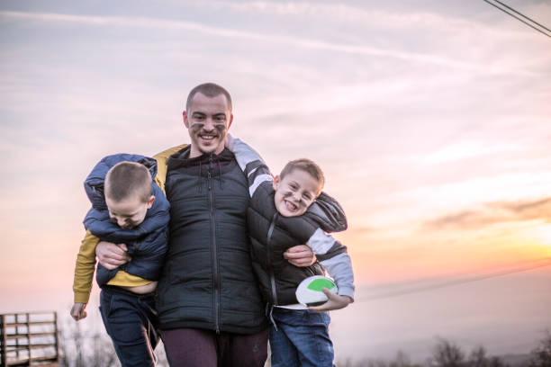 Family day Boys and father play american football man laughing hard stock pictures, royalty-free photos & images