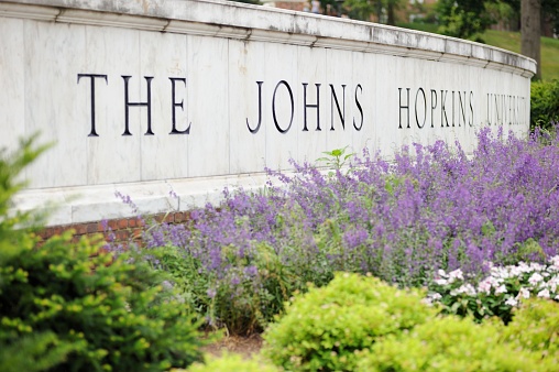 Baltimore, Maryland, USA - July 25, 2016: Close up of sign for The Johns Hopkins University in Baltimore, Maryland.  Sign located on North Charles Street along the east gate to campus.