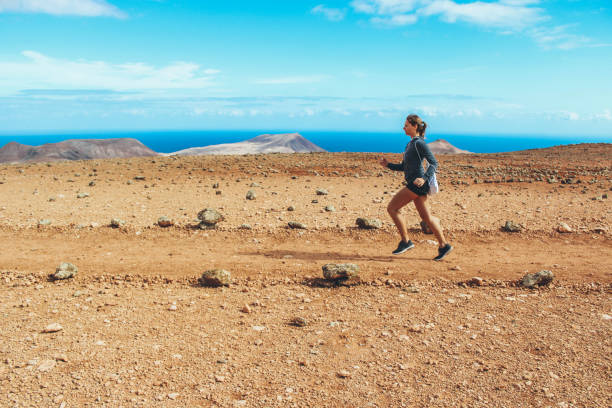 istock Young woman running on volcano 886135044