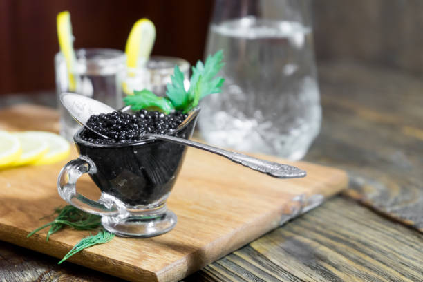 istock black caviar containers with spoon , close chilled vodka. Drank and ate. 886145398
