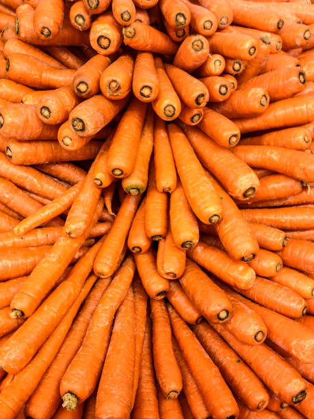 Carrot pattern A bin of carrots at a retail market. vitamin a foods stock pictures, royalty-free photos & images