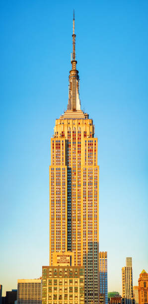 new york city's empire building detailed vertical panorama lit by sunset - vertical bright brightly lit vibrant color imagens e fotografias de stock