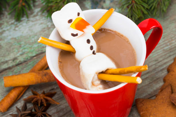 istock Red mug with hot chocolate with melted marshmallow snowman 886173450