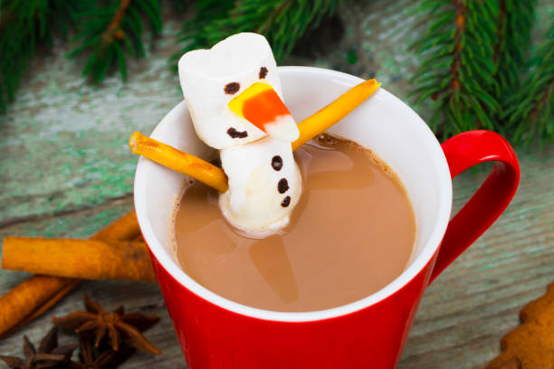 istock Red mug with hot chocolate with melted marshmallow snowman 886173498