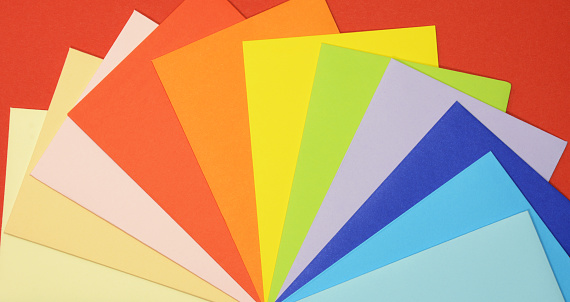 Colorful background on red fan view made from the envelopes of many colors