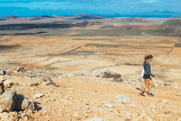 istock Young woman hiking with panoramic view on volcano 886176146