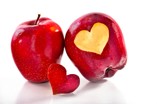 istock Two red apples and the cut-out heart 886176212