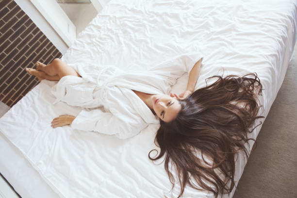 Young woman in bed relaxing