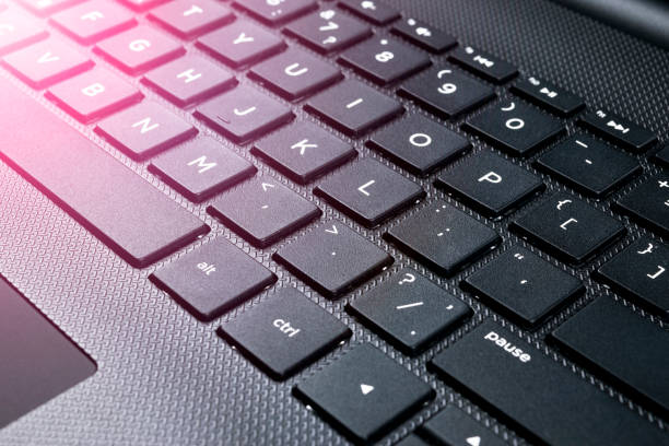 istock Close up view of a modern laptop computer keyboard keys. Soft lightning 886183896