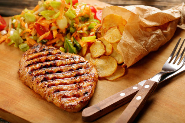 istock Grilled chicken breast fillet with potato chips 886183908