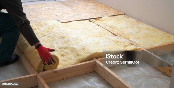 Work Composed Of Mineral Wool Insulation In The Floor Floor Heating Insulation Warm House Ecofriendly Insulation A Builder At Work Stock Photo - Download Image Now