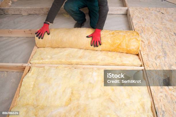 Worker Insulates The Floor With Mineral Wool Stock Photo - Download Image Now - Insulation, Stone Material, Wool