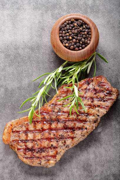 istock Grilled beef steak on wooden board 886202100