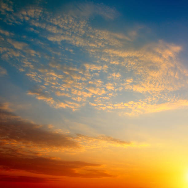 istock cloudy sky and bright sunrise over the horizon 886205028