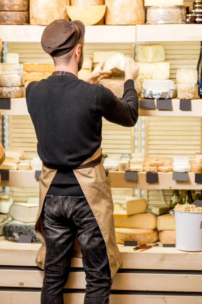 istock Cheese seller at the shop 886205638