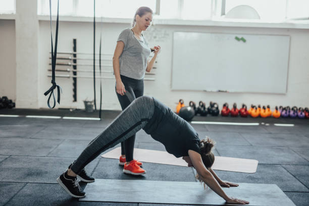 istock Mature woman in downward-facing dog pose 886205750