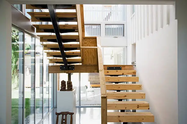 Photo of Interior of modern house, wooden stairway