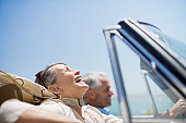 Mature couple driving in convertible