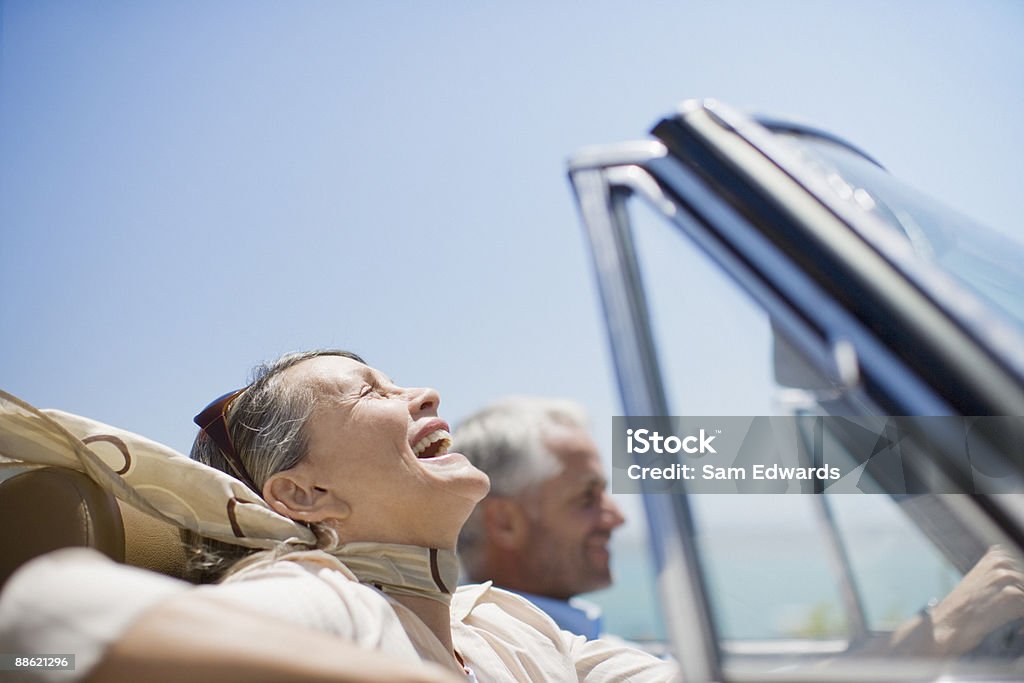 Mature couple driving in convertible  Luxury Stock Photo