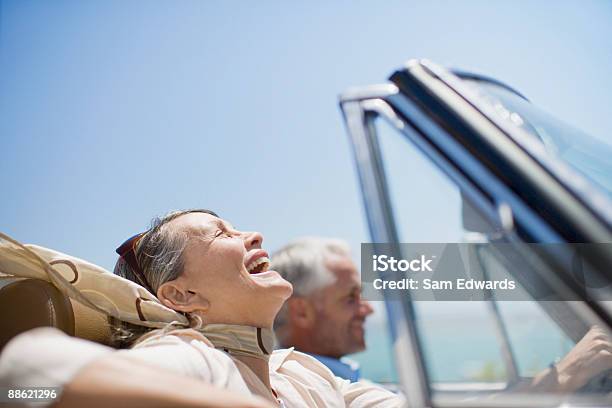 Mature Couple Driving In Convertible Stock Photo - Download Image Now - Luxury, Retirement, Driving