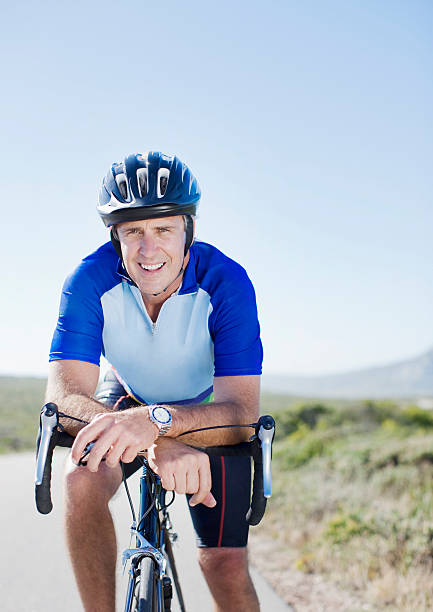 Man in helmet sitting on bicycle  spandex stock pictures, royalty-free photos & images