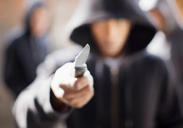 Photo of Man threatening with pocket knife