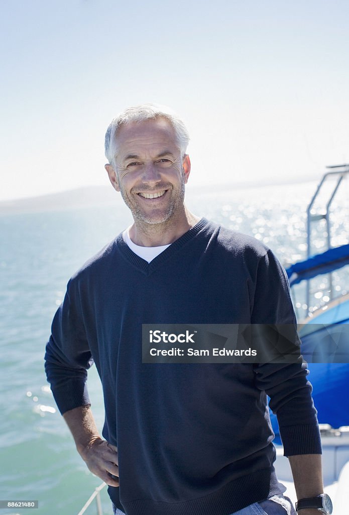 Man standing on deck of boat  Men Stock Photo