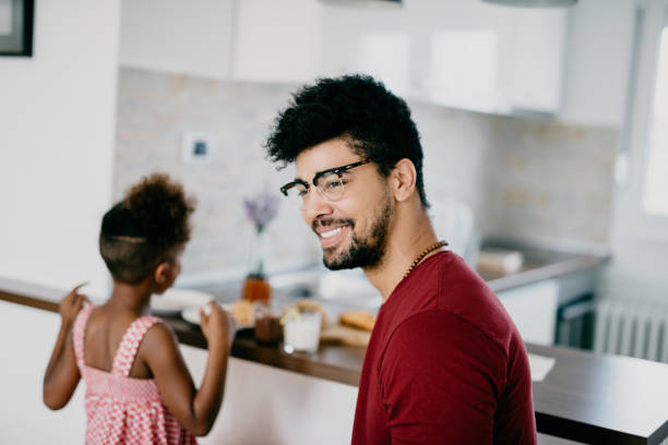 istock Smiling single father having breakfast with his daughter 886226452