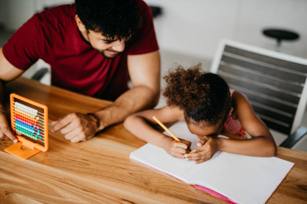 istock Daddy and his little girl doing homework 886227198