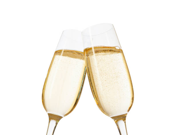 close-up of two glasses of champagne clinking together.  isolated on white  background. focus on near glass. - nobody alcohol champagne wine imagens e fotografias de stock