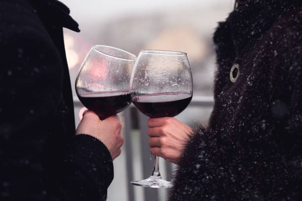 Crop couple with wineglasses in winter