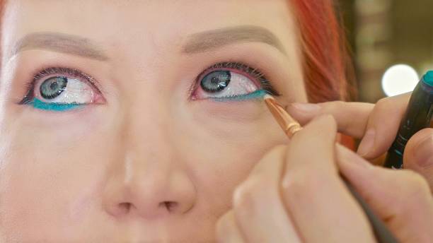 istock Make-up artist applying makeup to model's eye. Close up view. 886243540