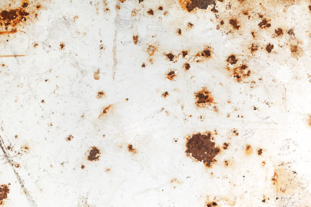 Bright rust stains texture paint showing through to rust underneath stock photo