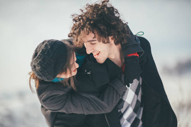 istock Smiling young couple having fun in the snow 886246996