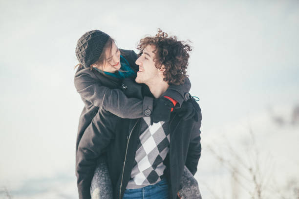 istock Smiling young couple having fun in the snow 886247138