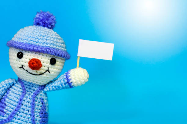 istock snowman with posters on a blue background, with exposure 886258178
