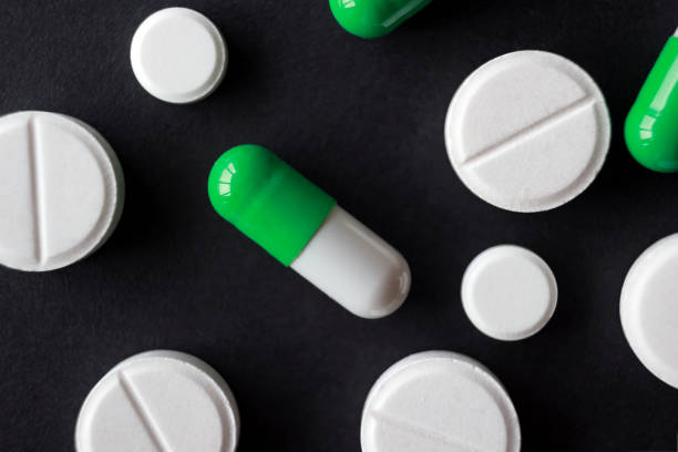 istock tablets of different shapes and sizes on a black background, close up 886258230