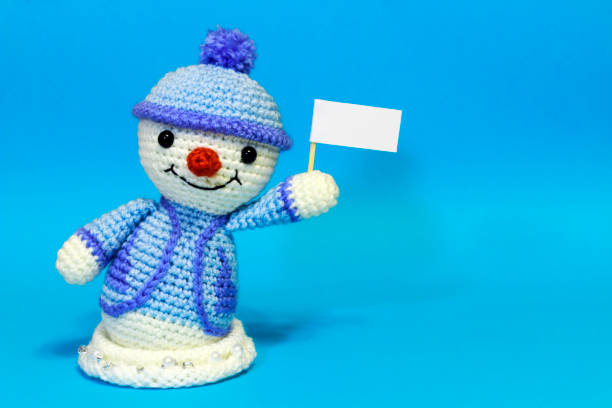 istock one with a snowman left with posters on a blue background 886258254