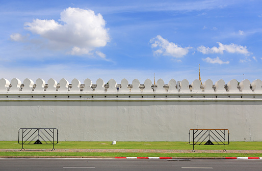 Background of white walls of temple against clear sky. The Big Wall at Wat pra kaew, Grand palace in bangkok Thailand.