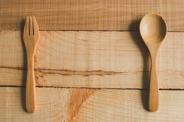 istock Spoons and fork on table, All is wooden for good health, copyspace for use 886268932