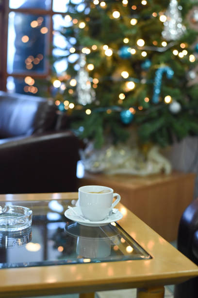 istock Coffee at the table in the background lights and Christmas tree 886276104