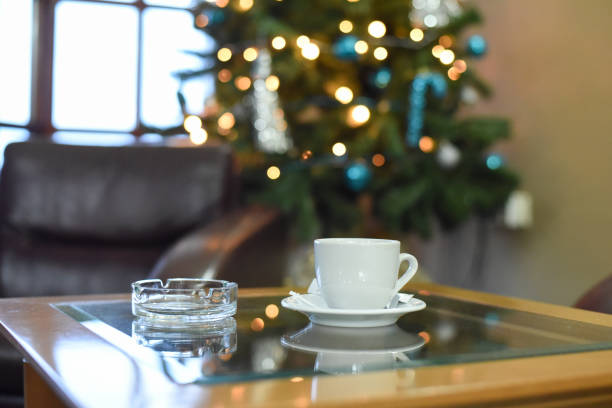 istock Coffee at the table in the background lights and Christmas tree 886276254