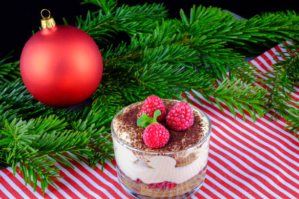 Food concept. Delicious desserts in plastic cases on factory with raspberry.