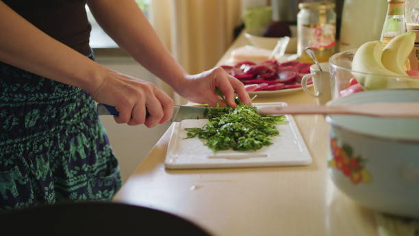 istock Woman Cuts Arugula Salad 886303228