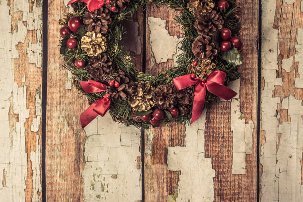 istock christmas wreath on wood background . 886305976