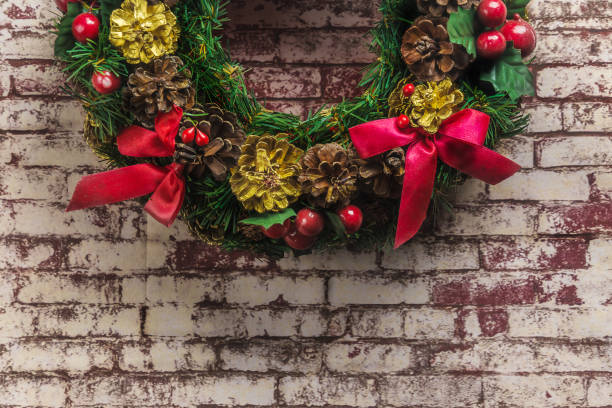 istock christmas wreath on  brick wall background . 886306266